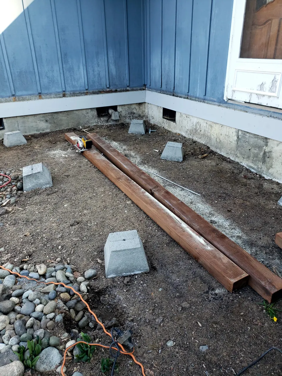 Deck footings being set during new deck build in Pierce County