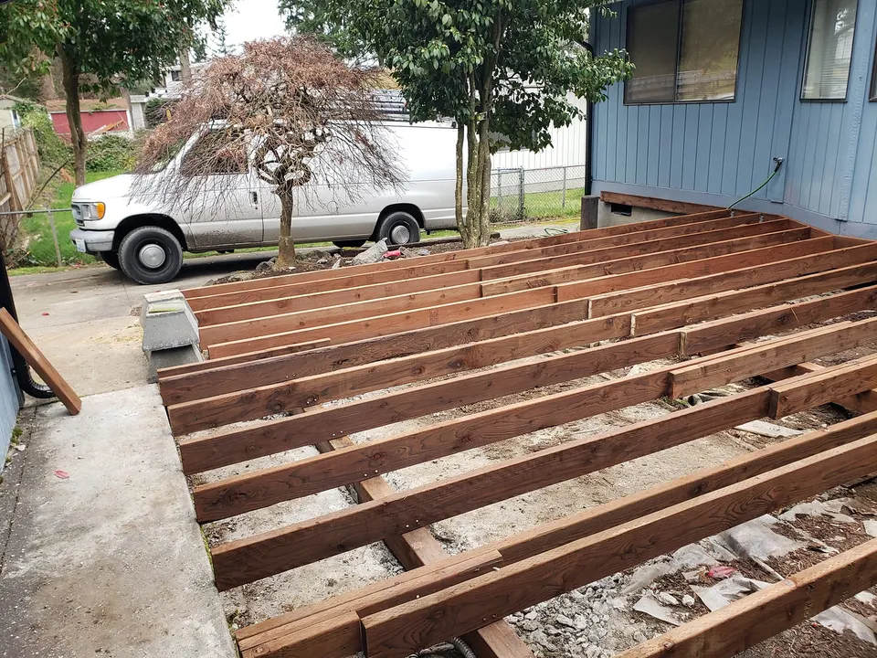 Deck framing in progress with stained lumber, Pierce County deck build