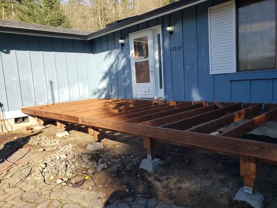 New deck frame under construction with pressure-treated lumber in Tacoma, WA