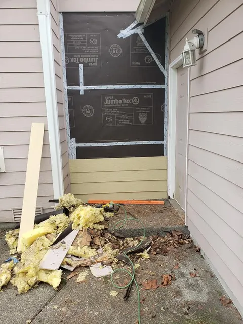 Weather barrier installed over new sheathing during siding replacement project